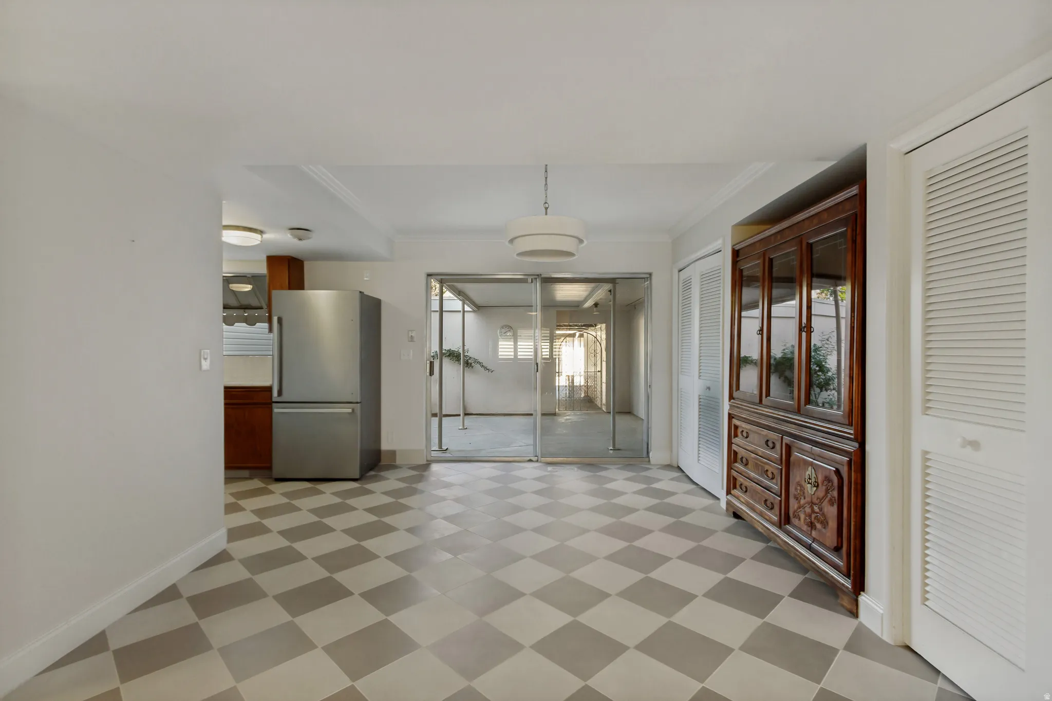 Chequered tile flooring, white walls, and a contemporary pendant light fixture
