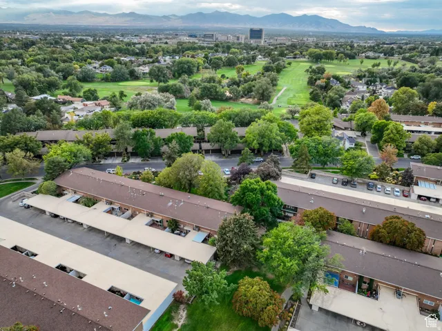 Aerial perspective showcasing residential buildings with brown roofs and multiple covered parking structures