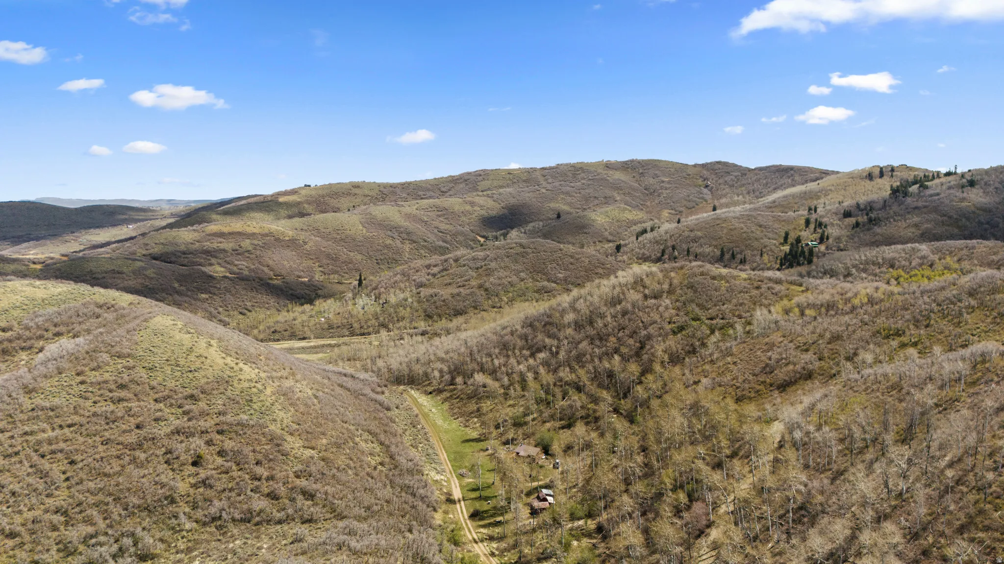 Expansive mountainous terrain with varied vegetation and natural contours