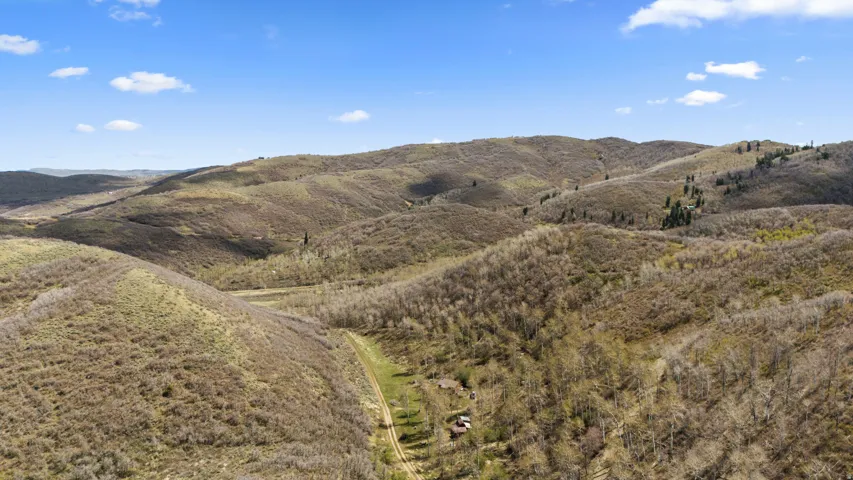 Expansive mountainous terrain with varied vegetation and natural contours