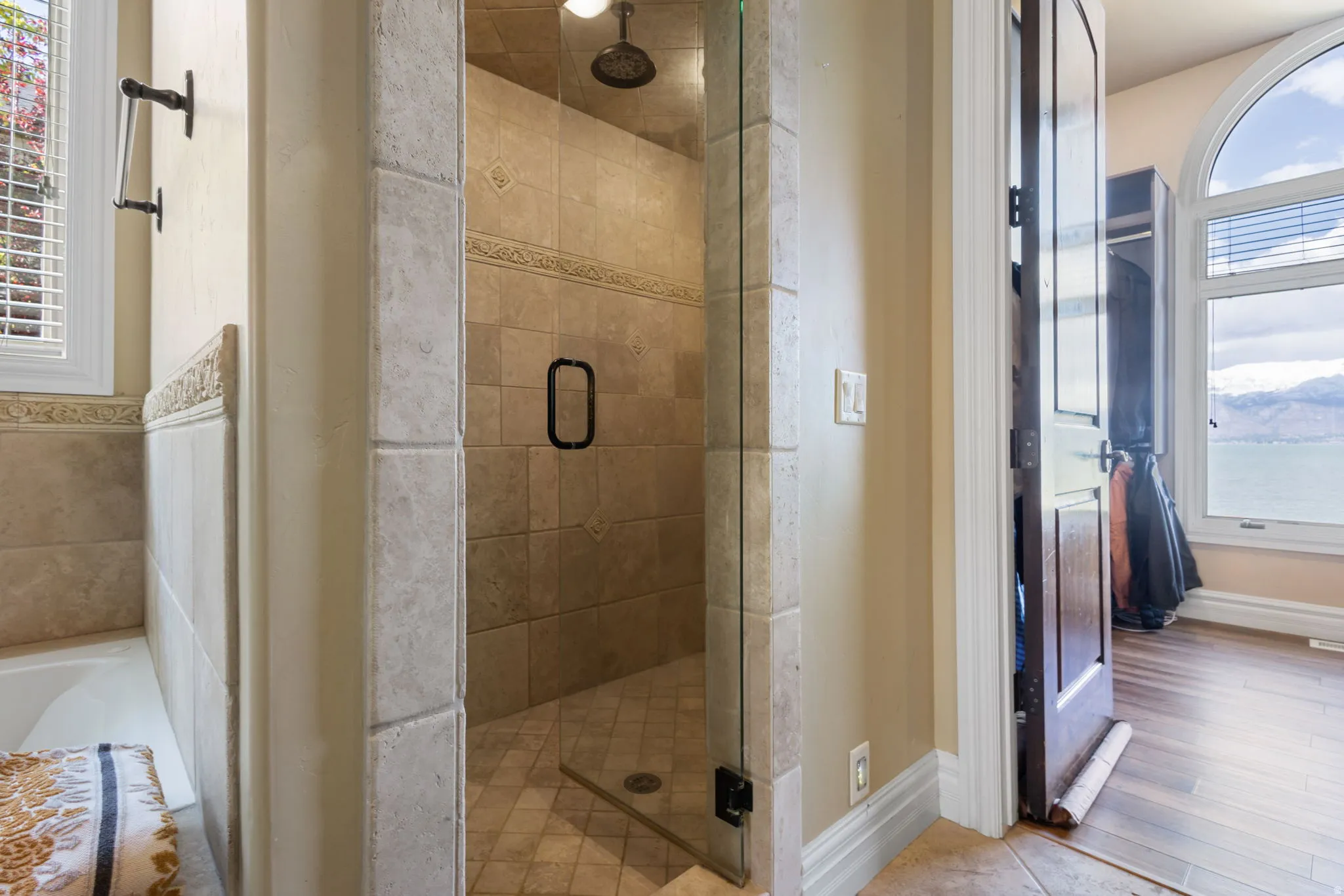Full bathroom featuring a garden tub and a shower stall