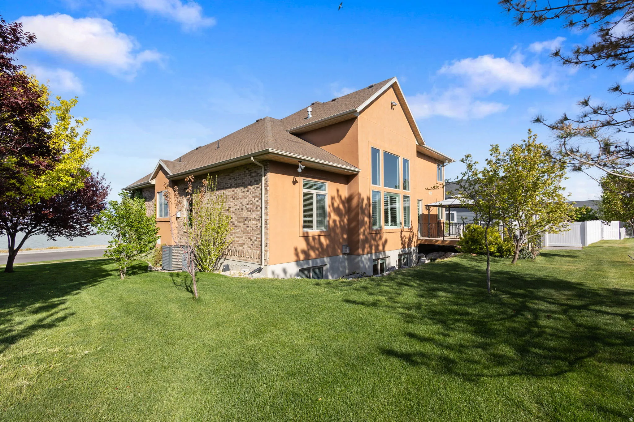 View of side of home with a yard and brick siding