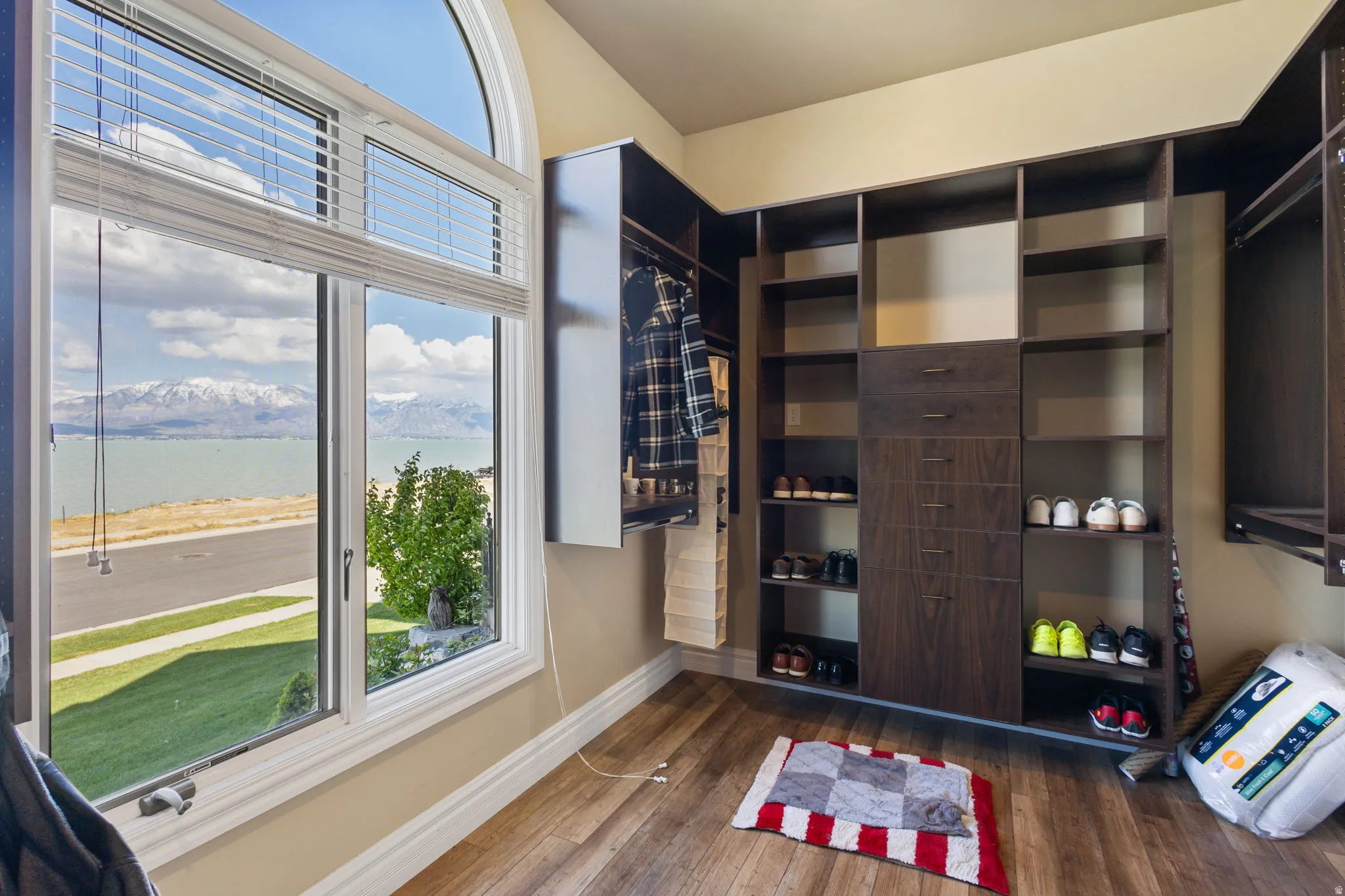 Walk in closet featuring dark wood-type flooring