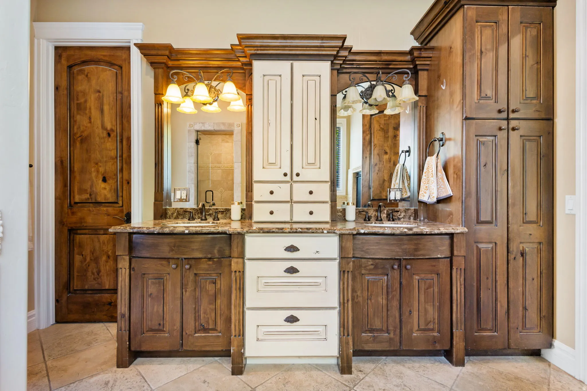 Bathroom with double vanity and baseboards