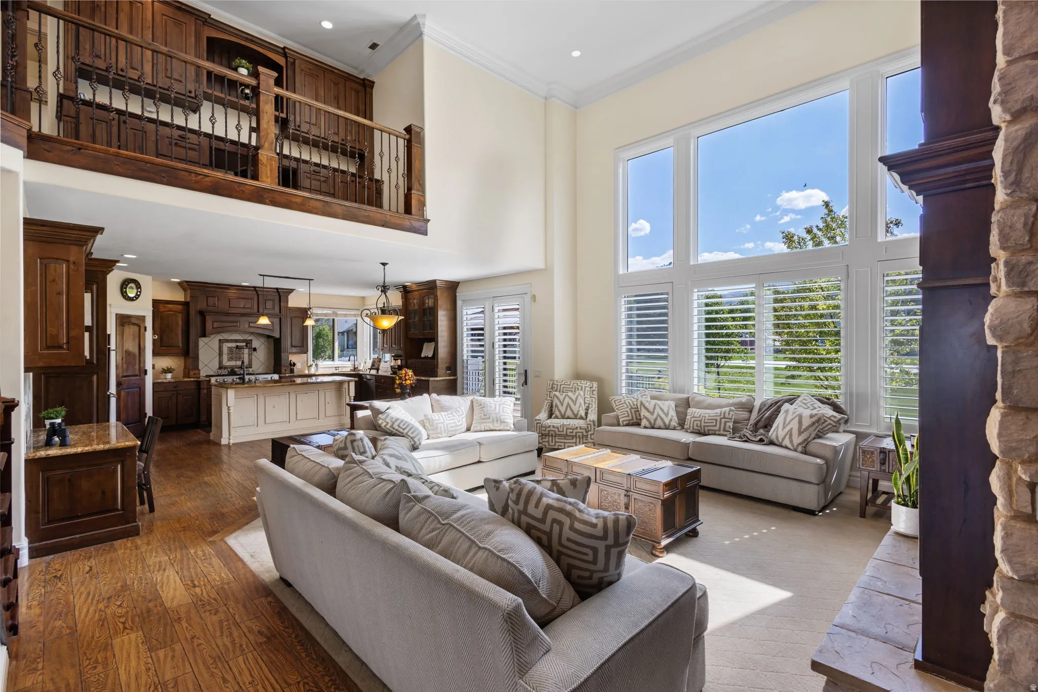 Living area featuring crown molding, a high ceiling, dark wood-style floors, and recessed lighting