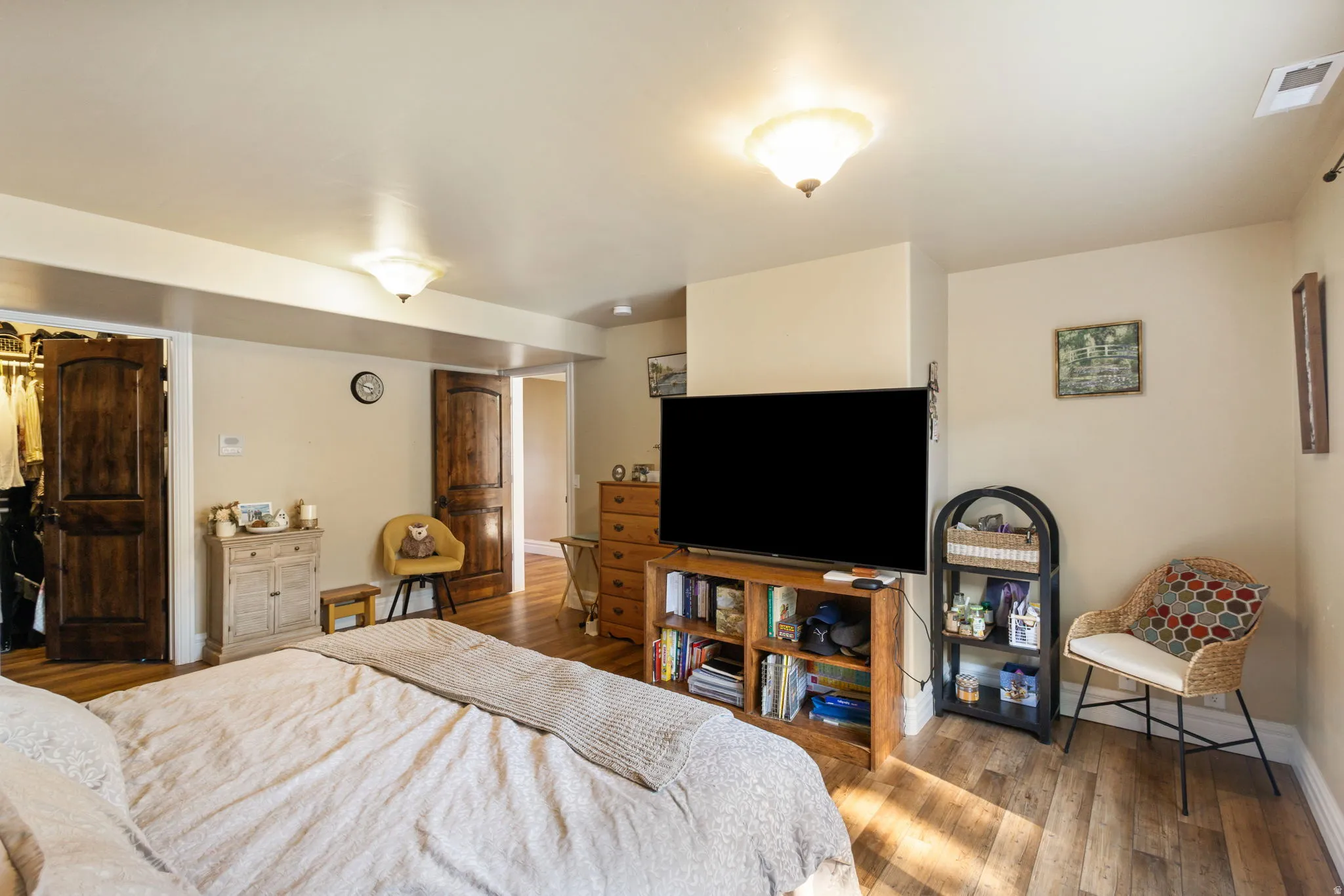 Bedroom with wood finished floors and baseboards
