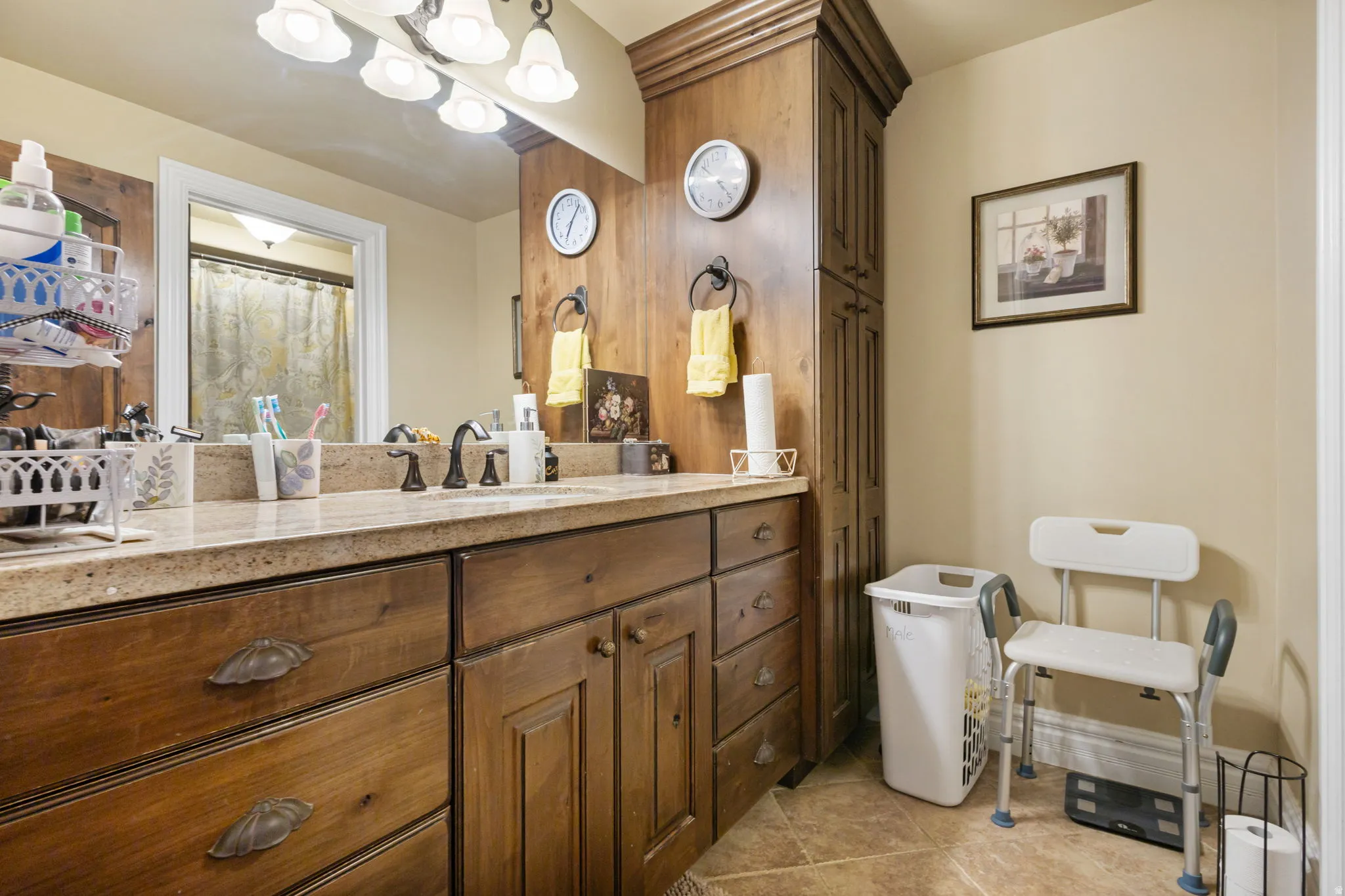 Full bath featuring vanity, a shower with shower curtain, and light tile patterned floors