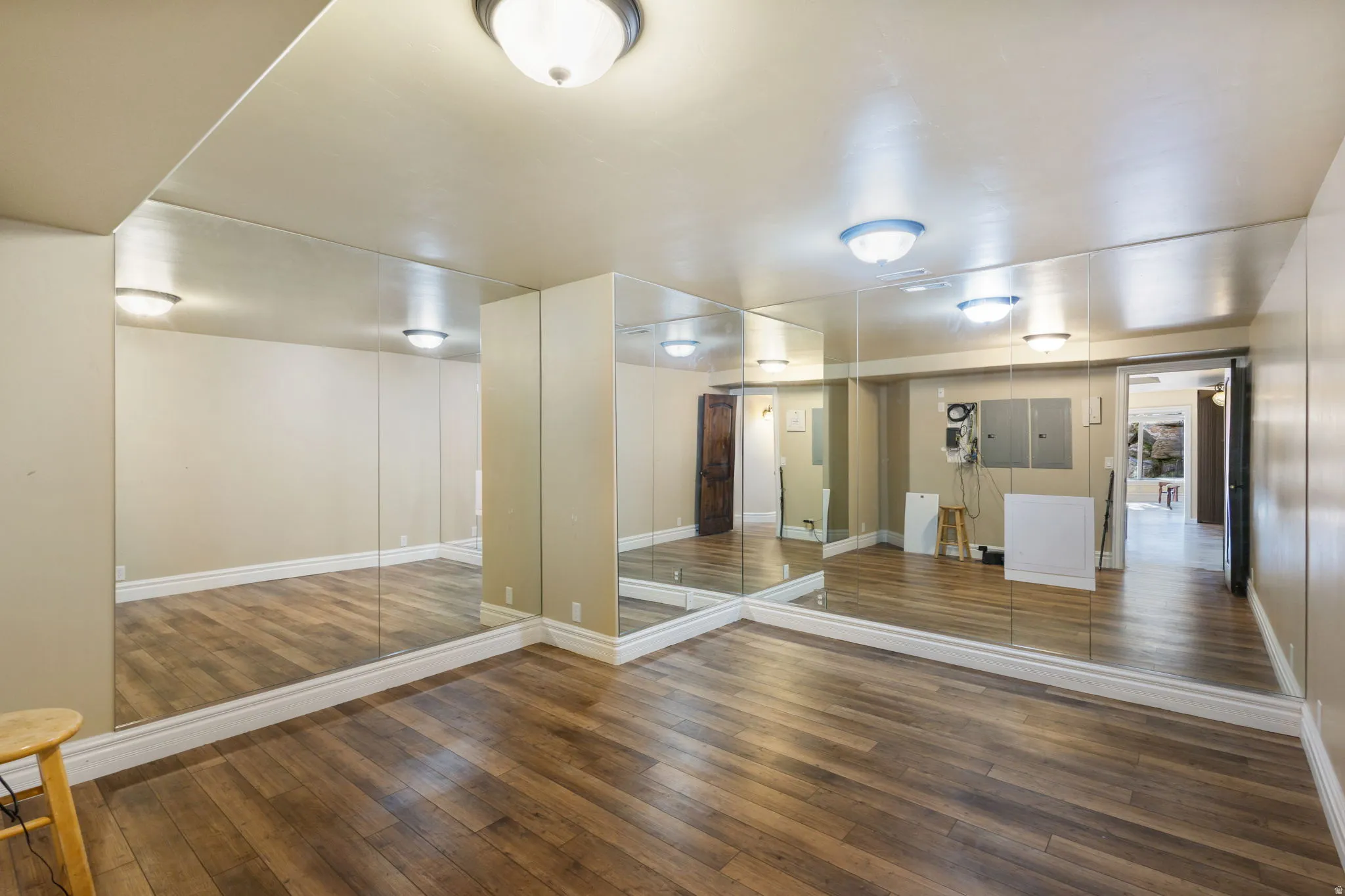 Unfurnished room featuring dark wood-style flooring and electric panel
