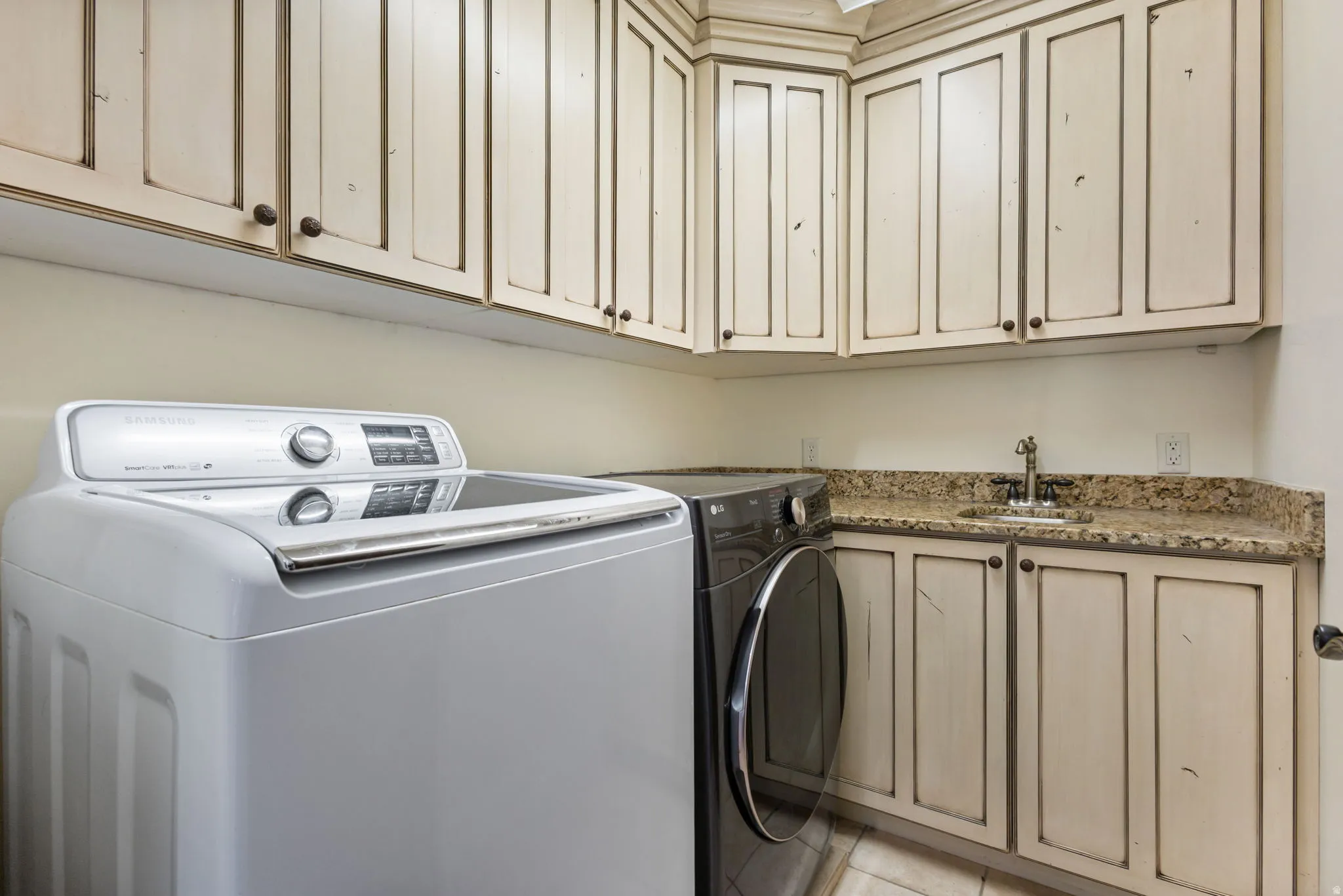 Laundry room featuring washer and clothes dryer and cabinet space