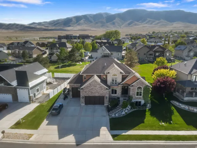 Aerial perspective of suburban area featuring a mountainous background