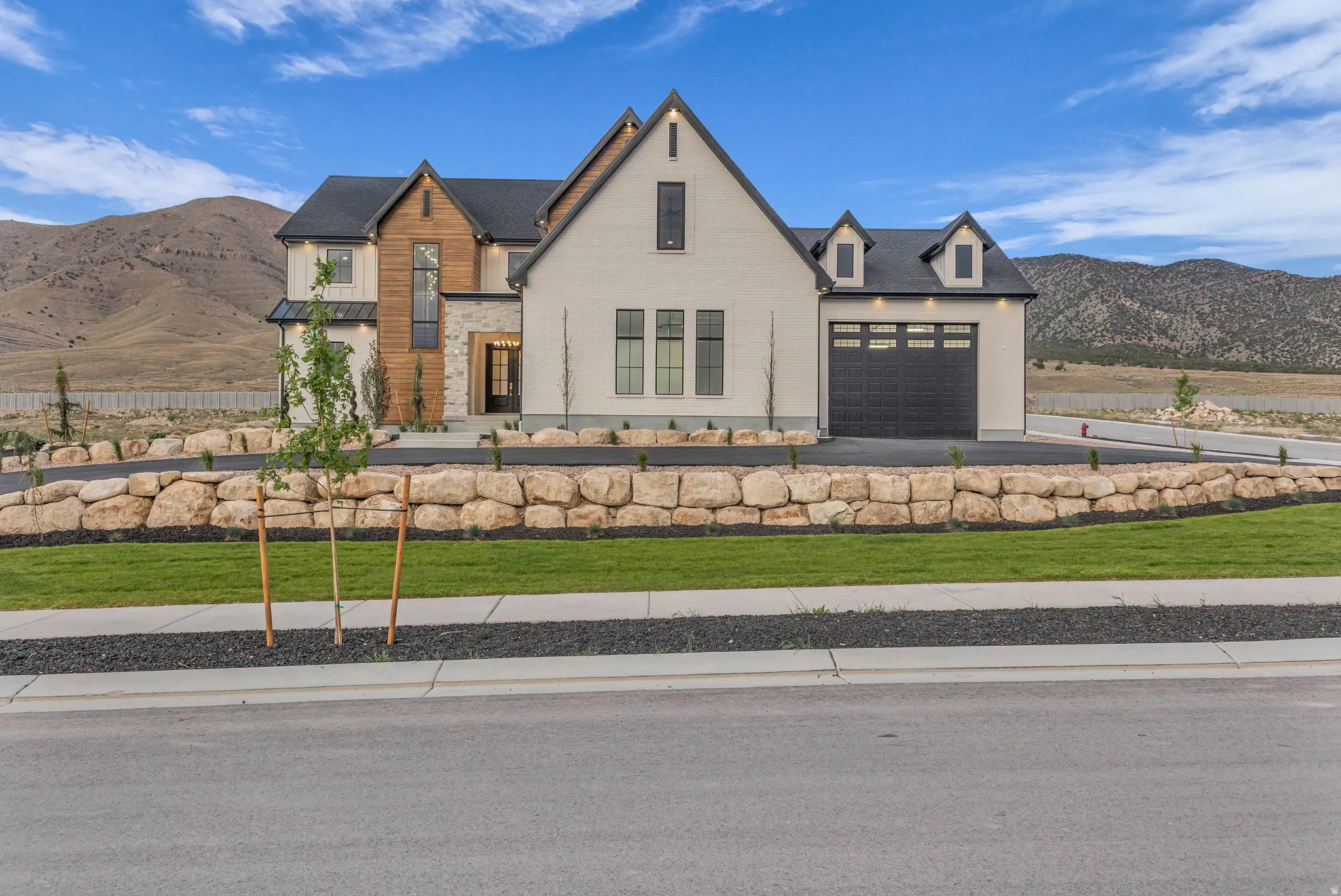 Modern farmhouse exterior with white brick and wood-panel accents