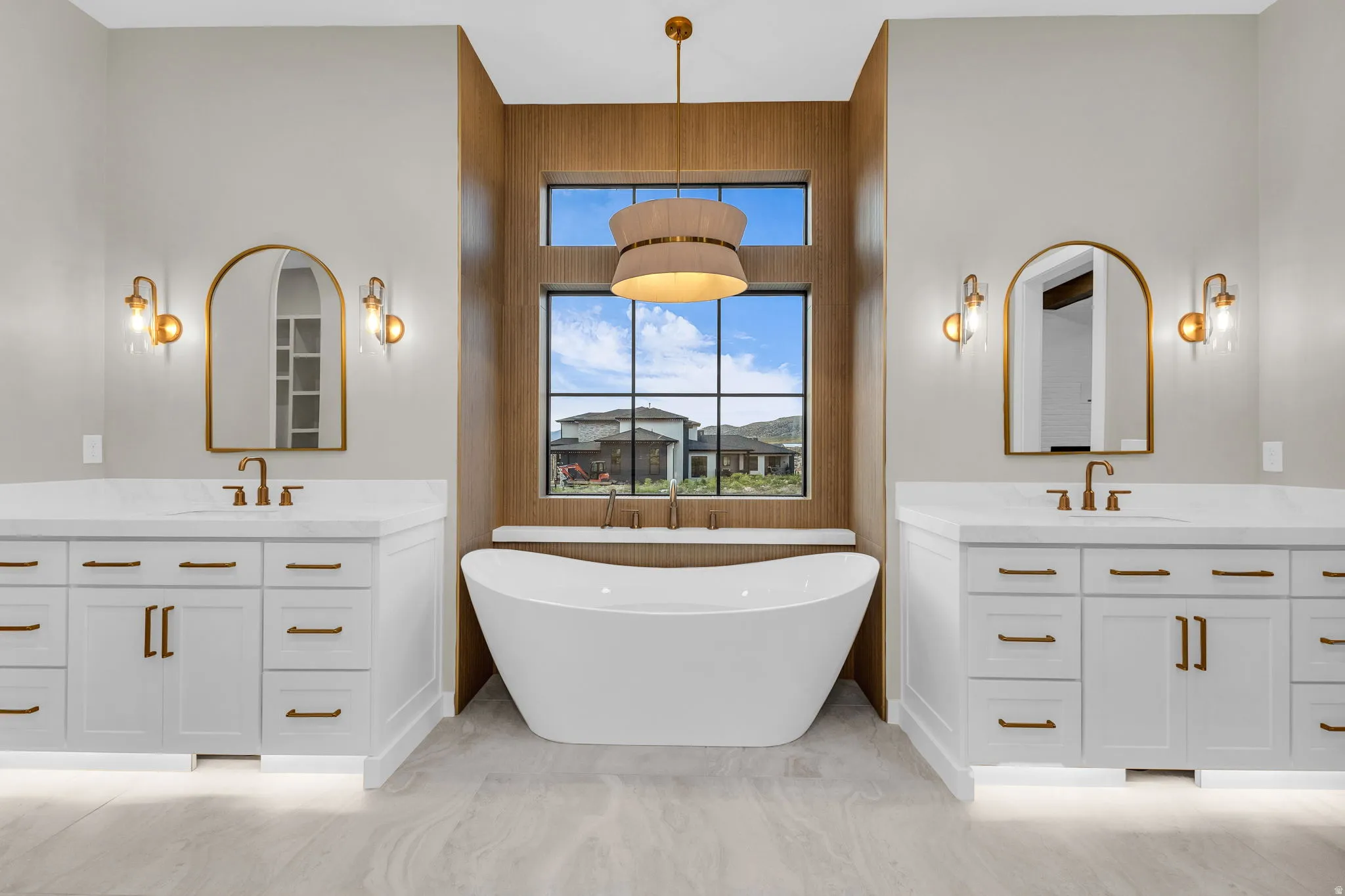 Freestanding soaking tub with a wood-finish accent wall
