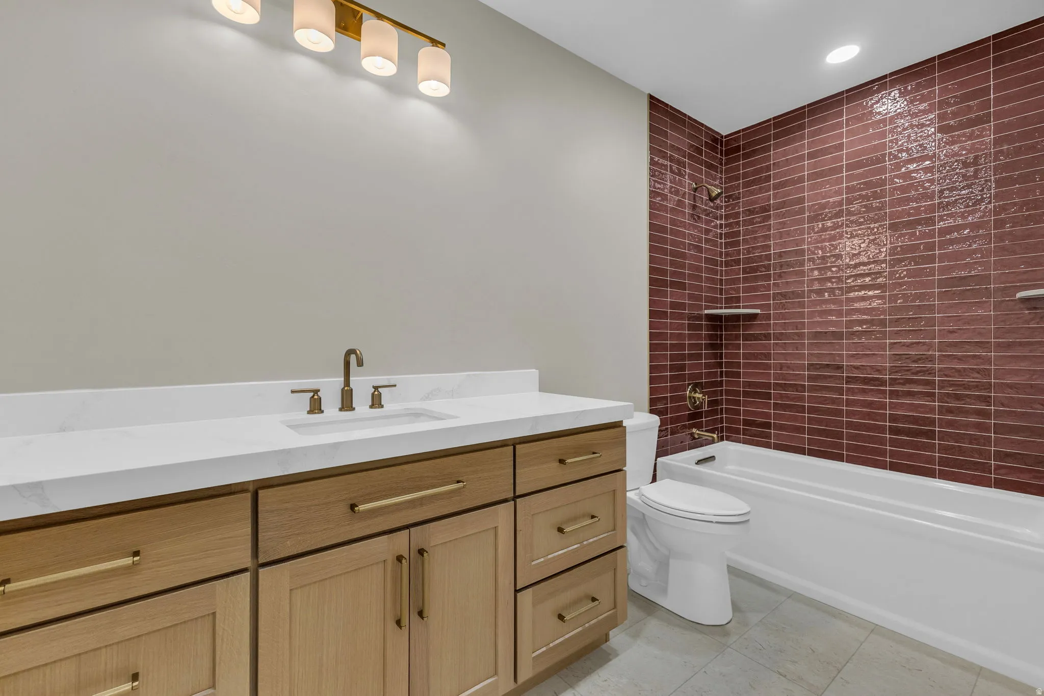 Bathroom featuring a light wood-finish vanity with a white countertop and integrated sink