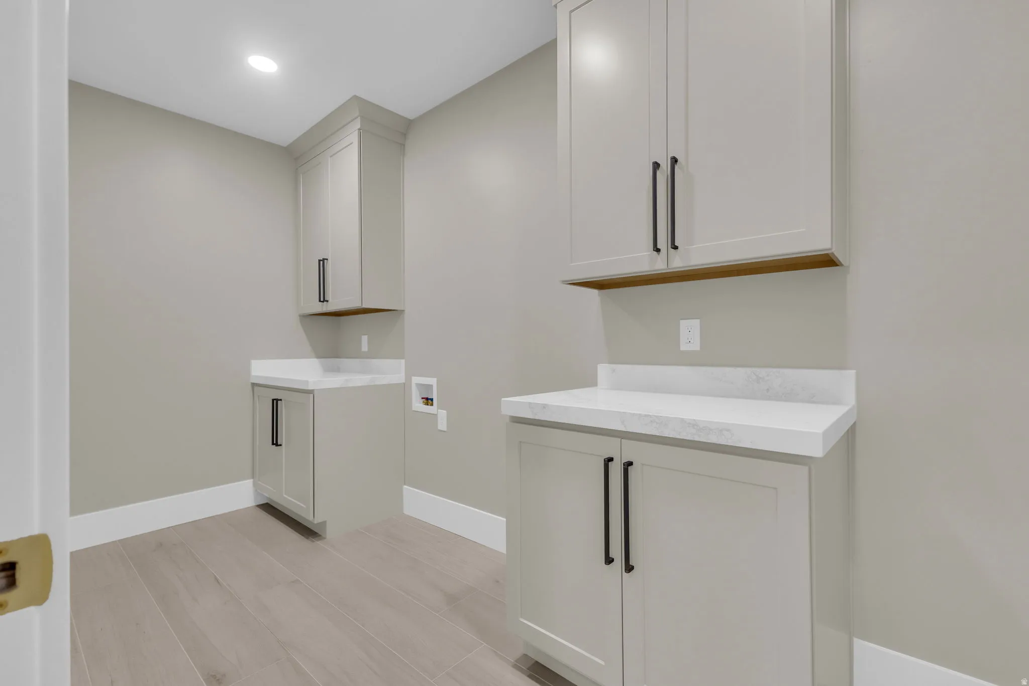 Light wood-finish flooring complements the neutral wall color