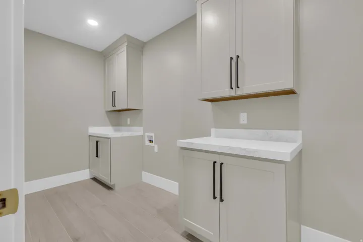 Light wood-finish flooring complements the neutral wall color