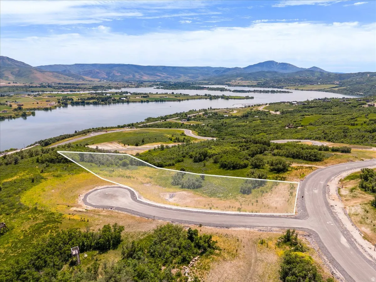 Aerial overview of property's location featuring property parcel outlined and a water and mountain view