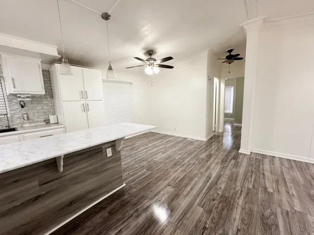 Open-concept living space with wood-finish flooring