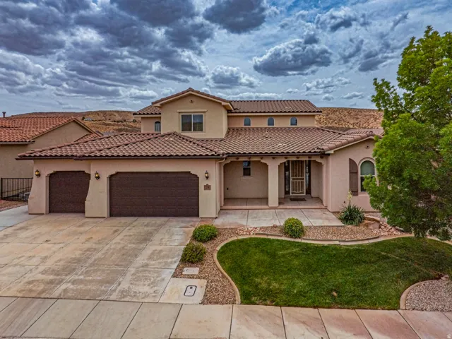 Stucco exterior with a tiled roof and a two-car garage