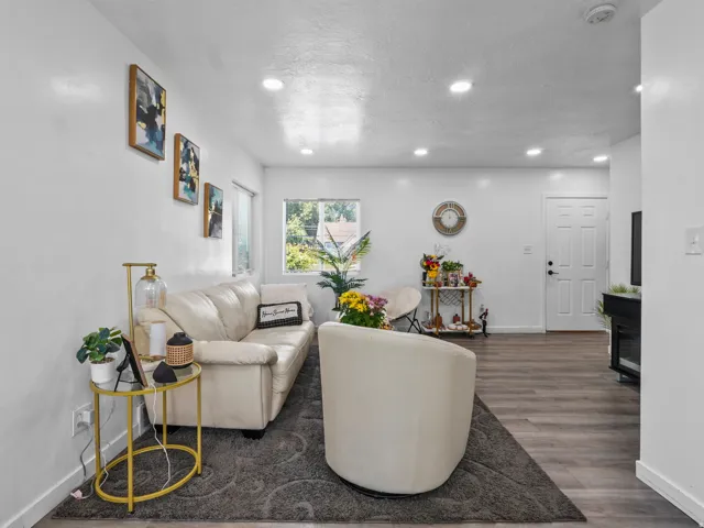 Open-concept living space featuring wood-finish flooring and recessed lighting