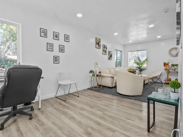 Spacious interior featuring wood-finish flooring and recessed lighting