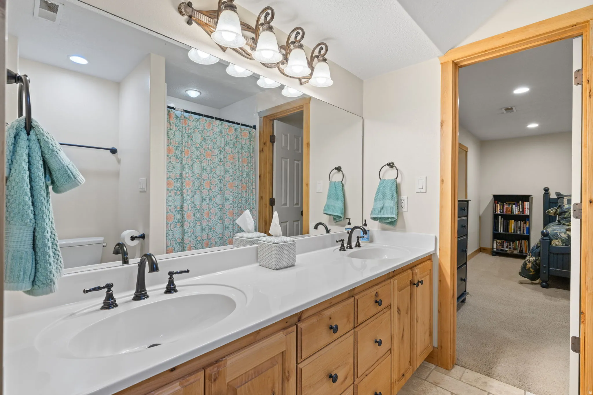 Double vanity with white solid surface countertop and undermount sinks