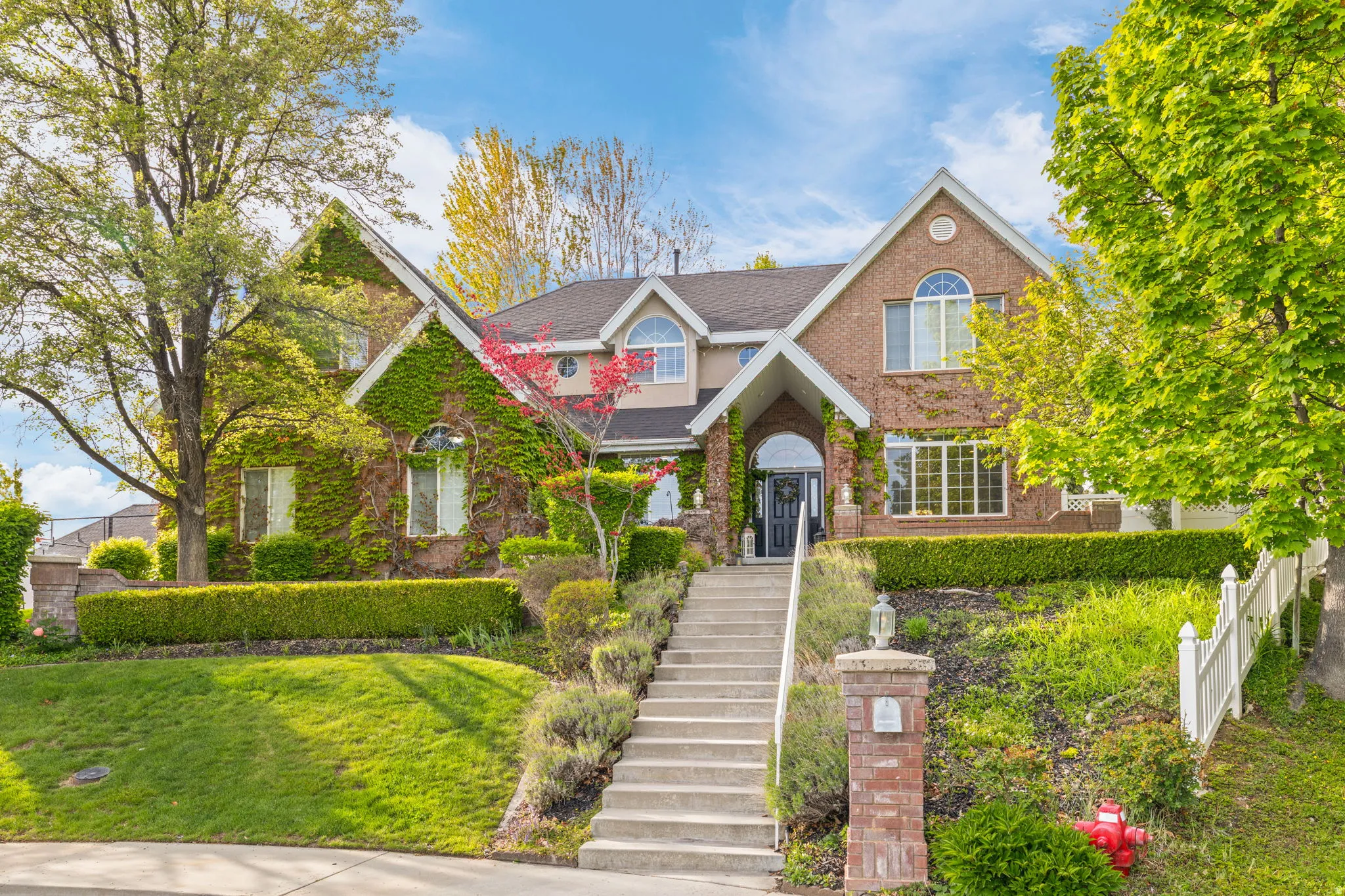 Brick facade residence featuring climbing ivy accents