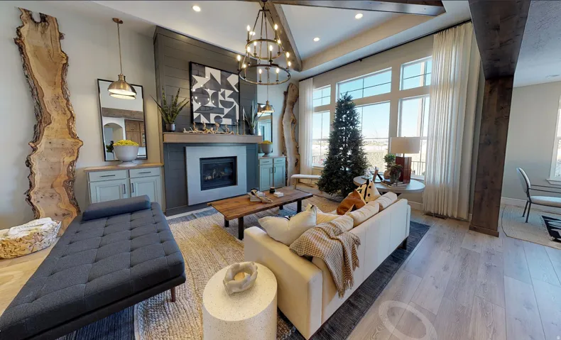 Living area featuring a fireplace with a light-colored surround and a dark wood mantel, flanked by built-in cabinetry
