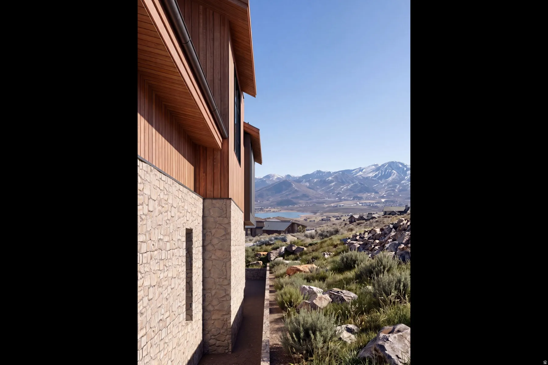 Stone and wood-panel exterior with a mountain backdrop