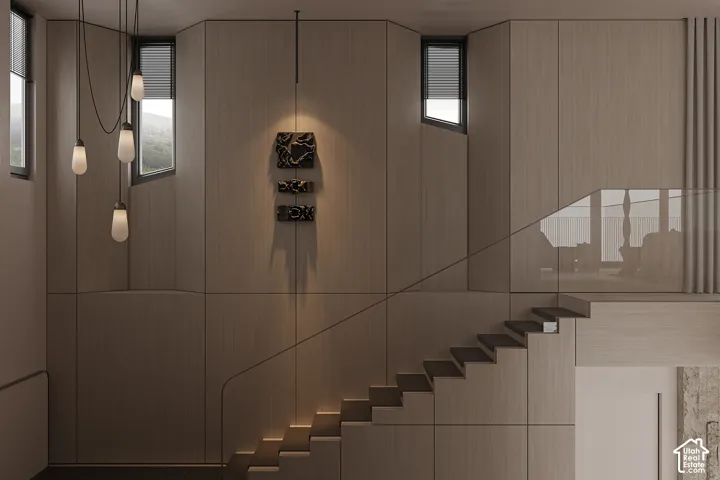 Architectural staircase featuring wood-finish paneling, minimalist glass railing, and integrated lighting