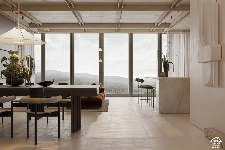Open-concept space featuring expansive floor-to-ceiling windows, exposed beam ceiling, large format tile flooring, a substantial island with a built-in sink, and a modern dining area