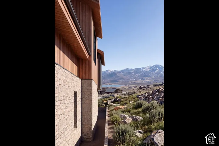 Exterior facade featuring stone veneer and vertical wood siding