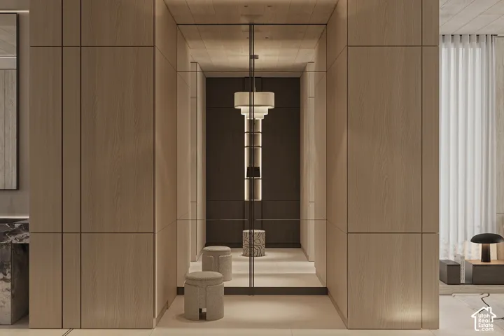Hallway featuring extensive wood-finish paneling, integrated lighting, a full-height mirror, and a contemporary chandelier fixture