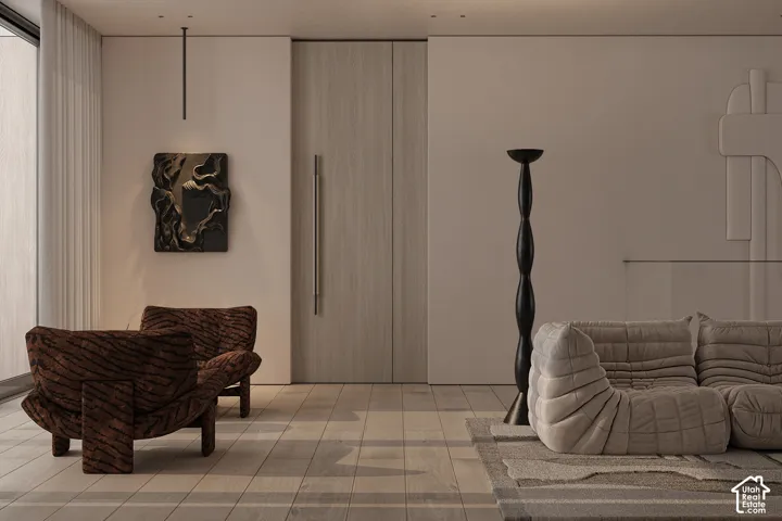 Spacious interior featuring wood-finish flooring, a full-height wood panel door, and integrated recessed lighting