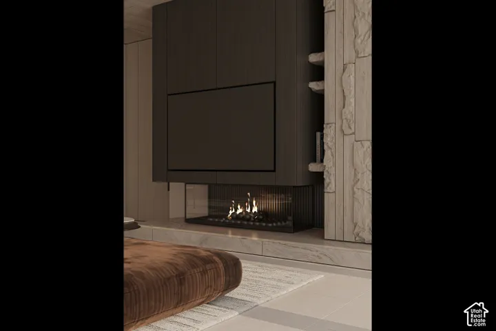 Integrated media wall featuring a recessed linear fireplace with glass enclosure, dark wood-finish paneling, and stacked stone accents