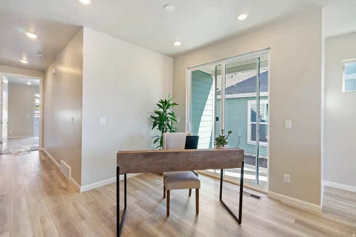Open concept interior featuring wide plank wood-finish flooring throughout