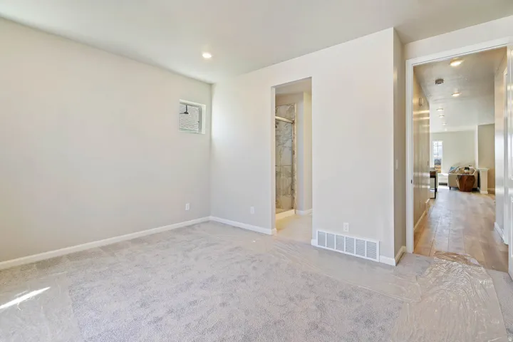 Carpeted room with recessed lighting and a transom window