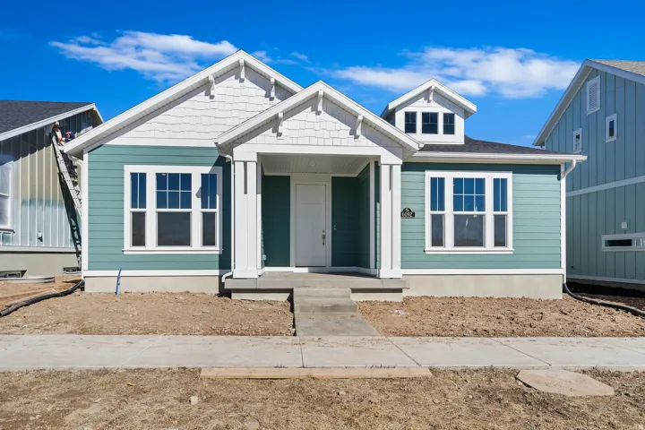 Contemporary home exterior featuring teal siding and white trim