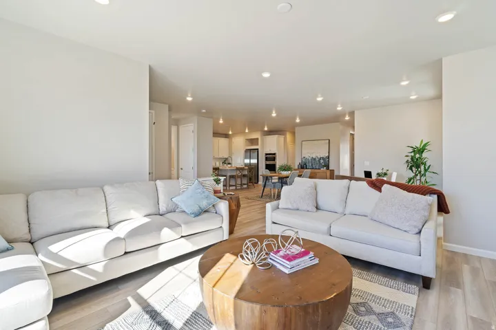 Bright living area featuring recessed lighting, light-toned walls, and wood-finish flooring