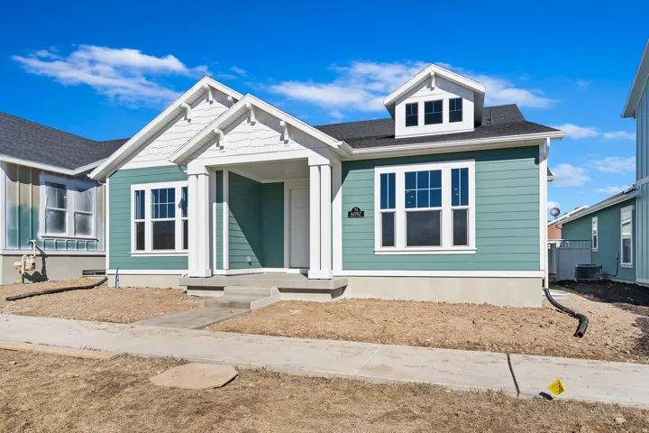 Contemporary single-story residence featuring light teal siding and white trim
