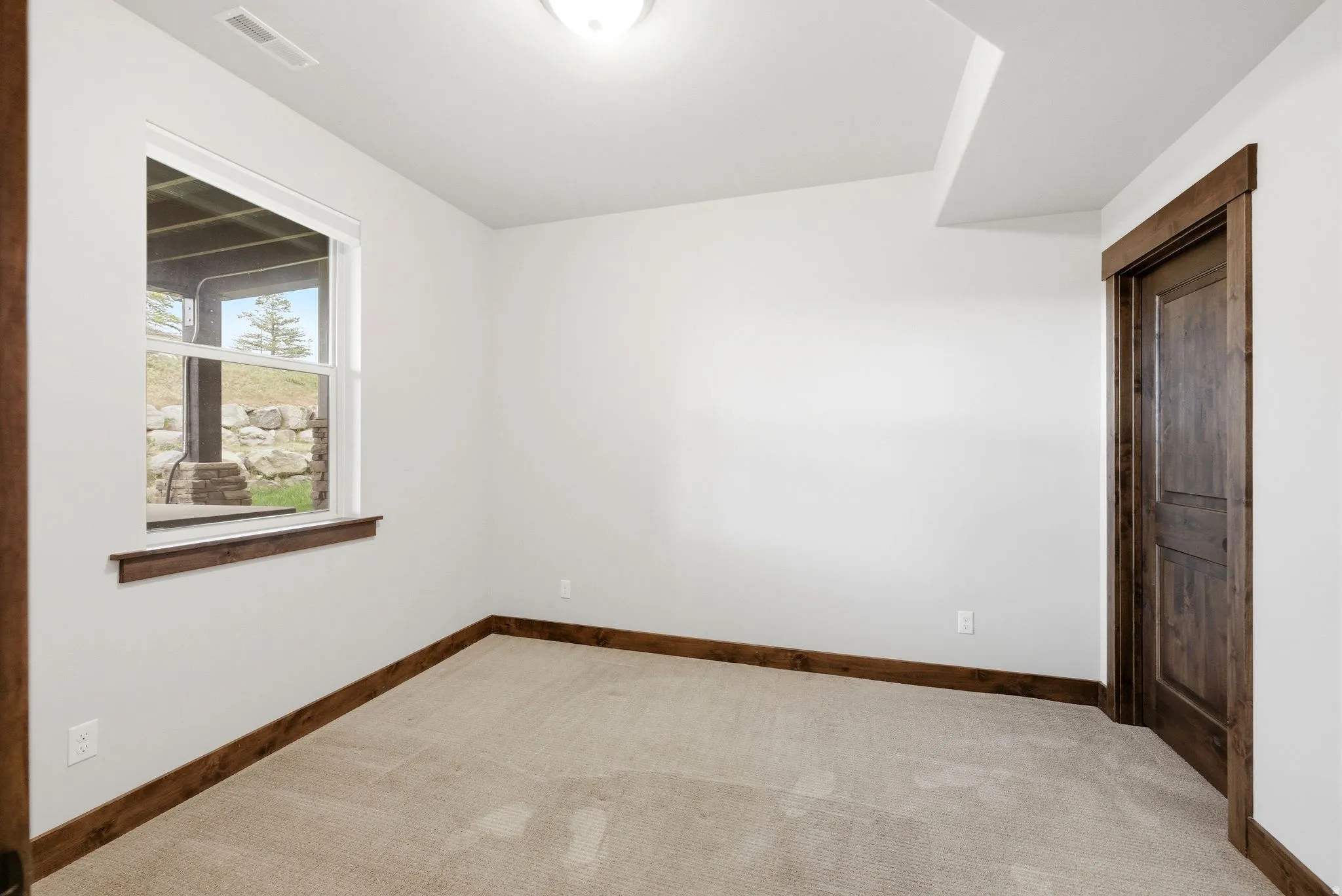 Neutral wall paint with contrasting wood-finish trim and doors