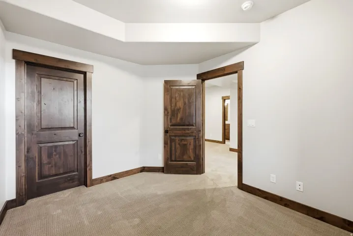 Room featuring light-colored carpeting and white walls