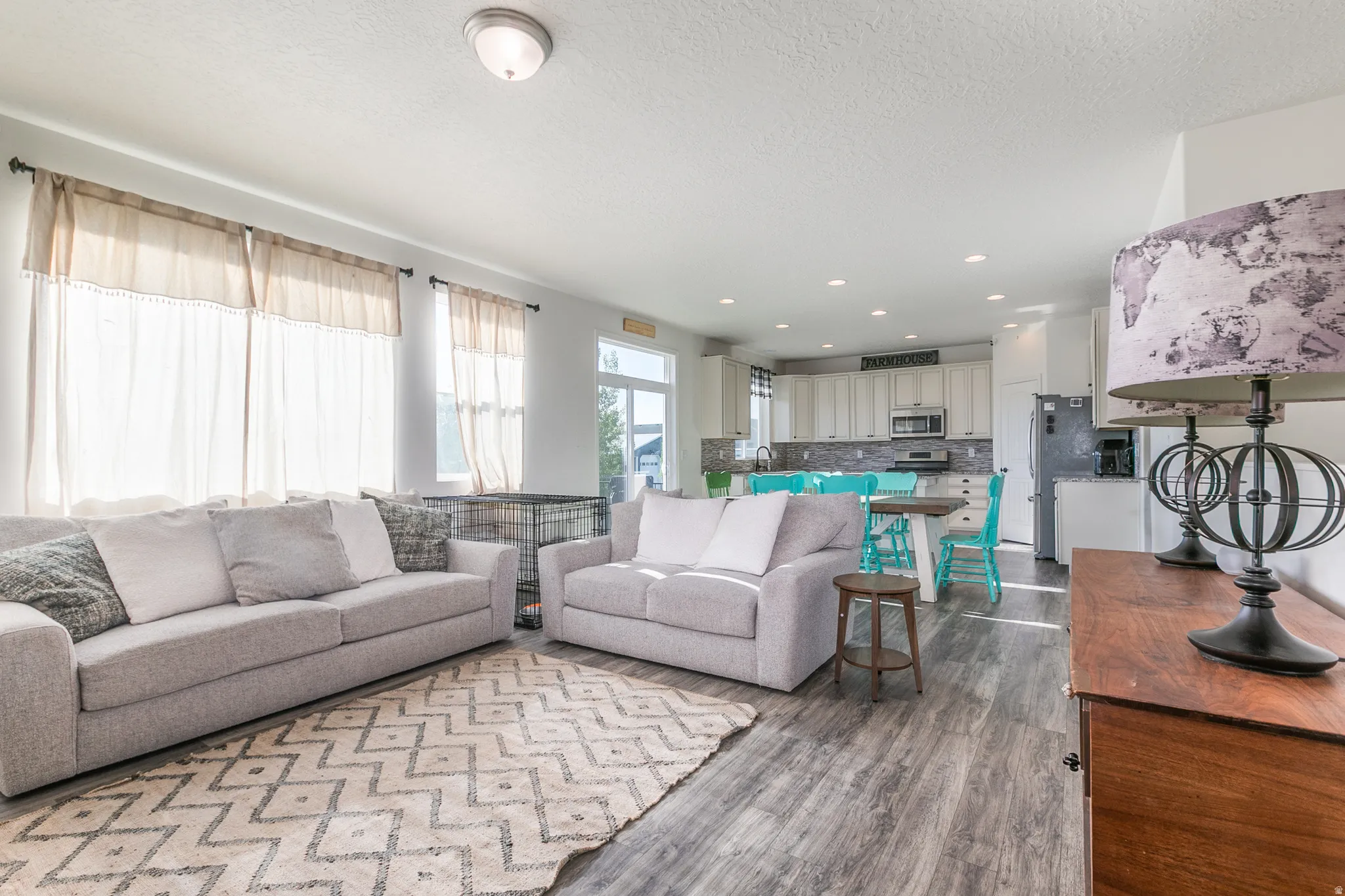 Open-concept living space featuring wood-finish flooring and multiple windows