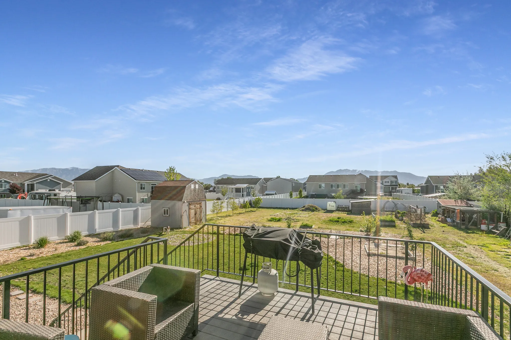 Expansive outdoor deck featuring composite decking and black metal railings