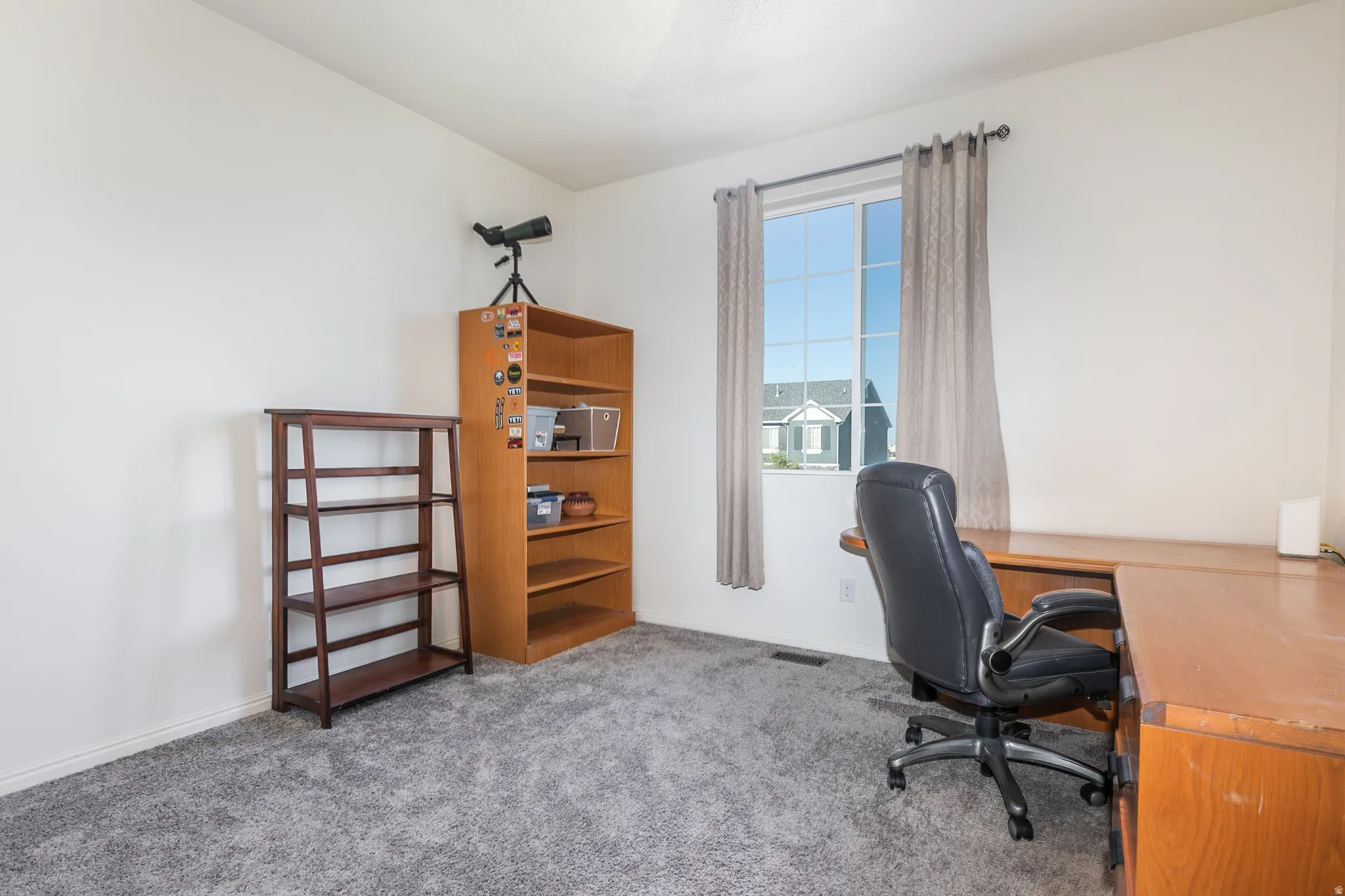 Carpeted room with a double-pane window