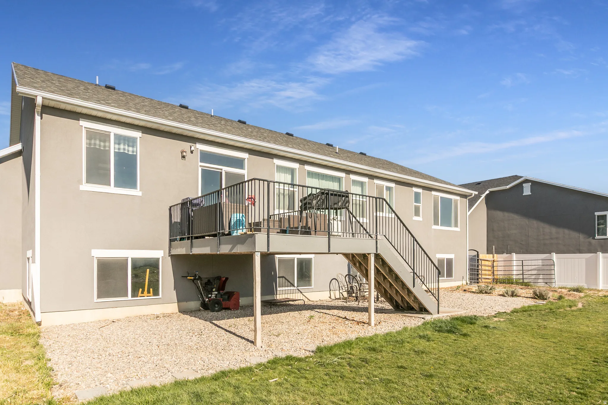 Exterior deck with black metal railings and stairs, providing outdoor access from the upper level