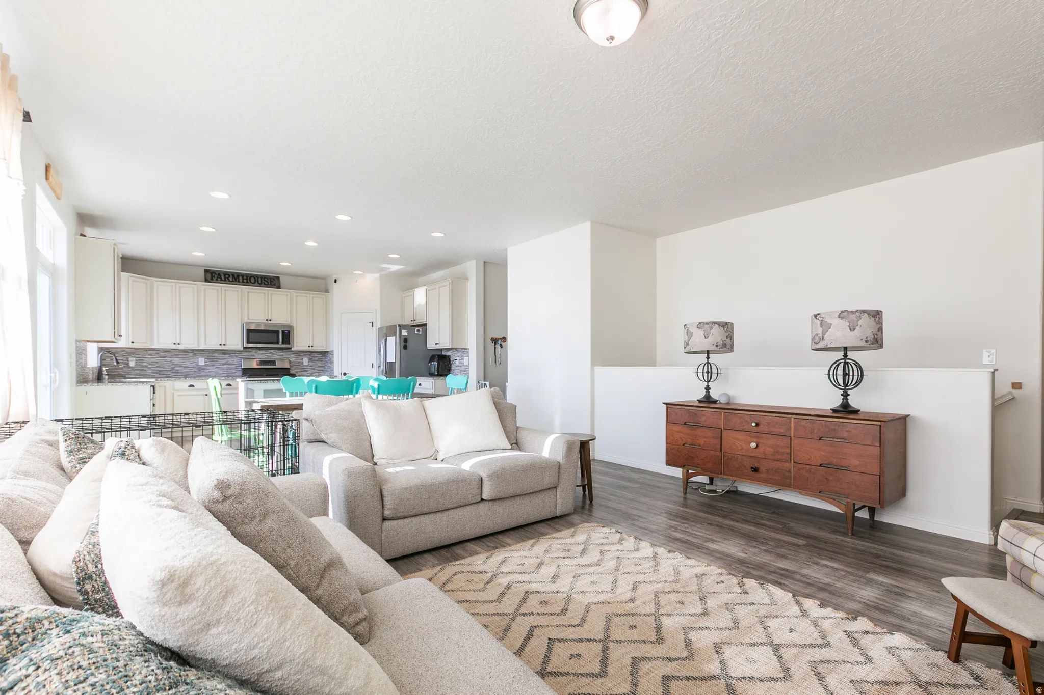 Open-concept living space featuring wood-finish flooring and recessed lighting