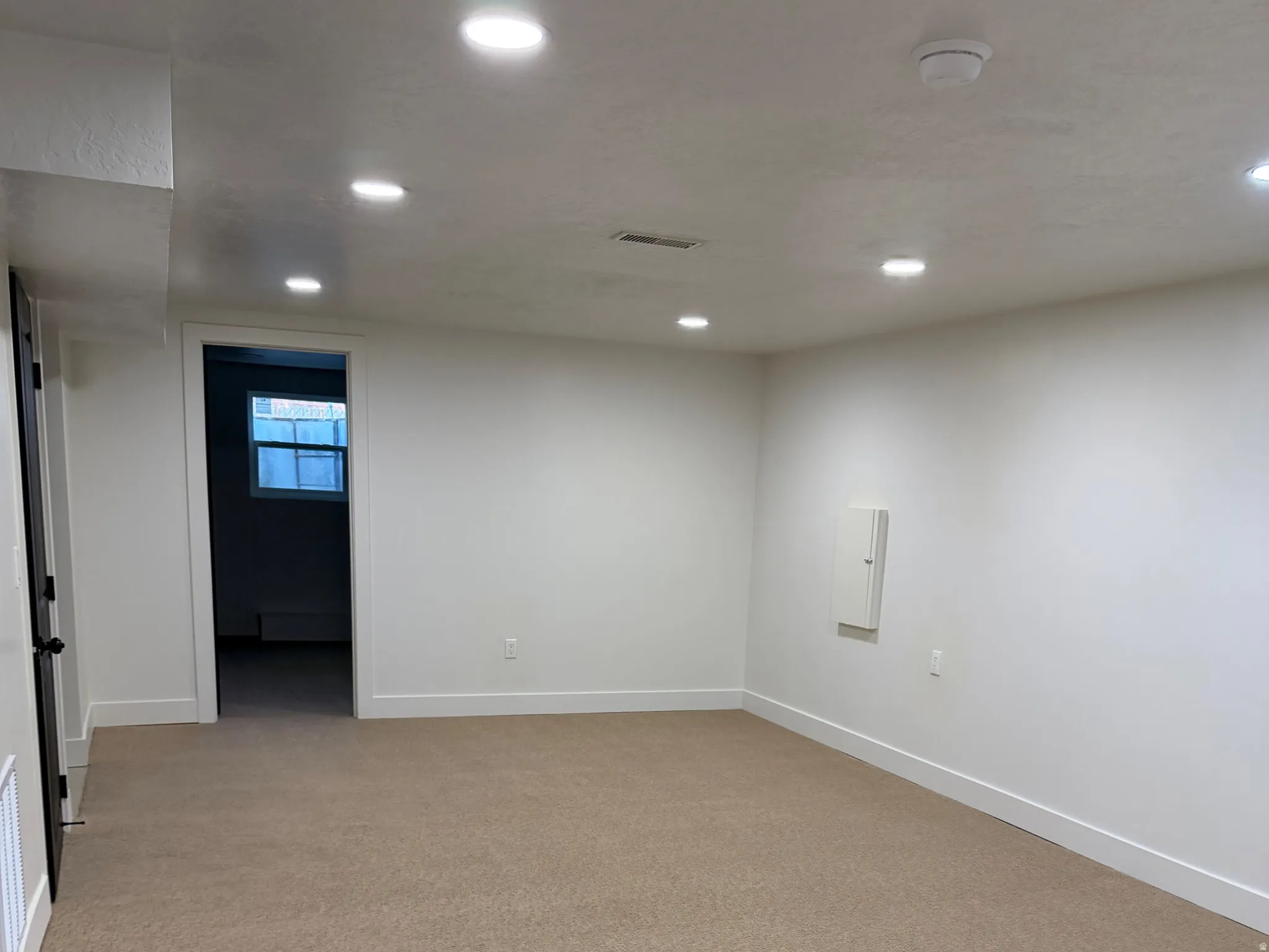 Spare room with light colored carpet, recessed lighting, and a smoke detector