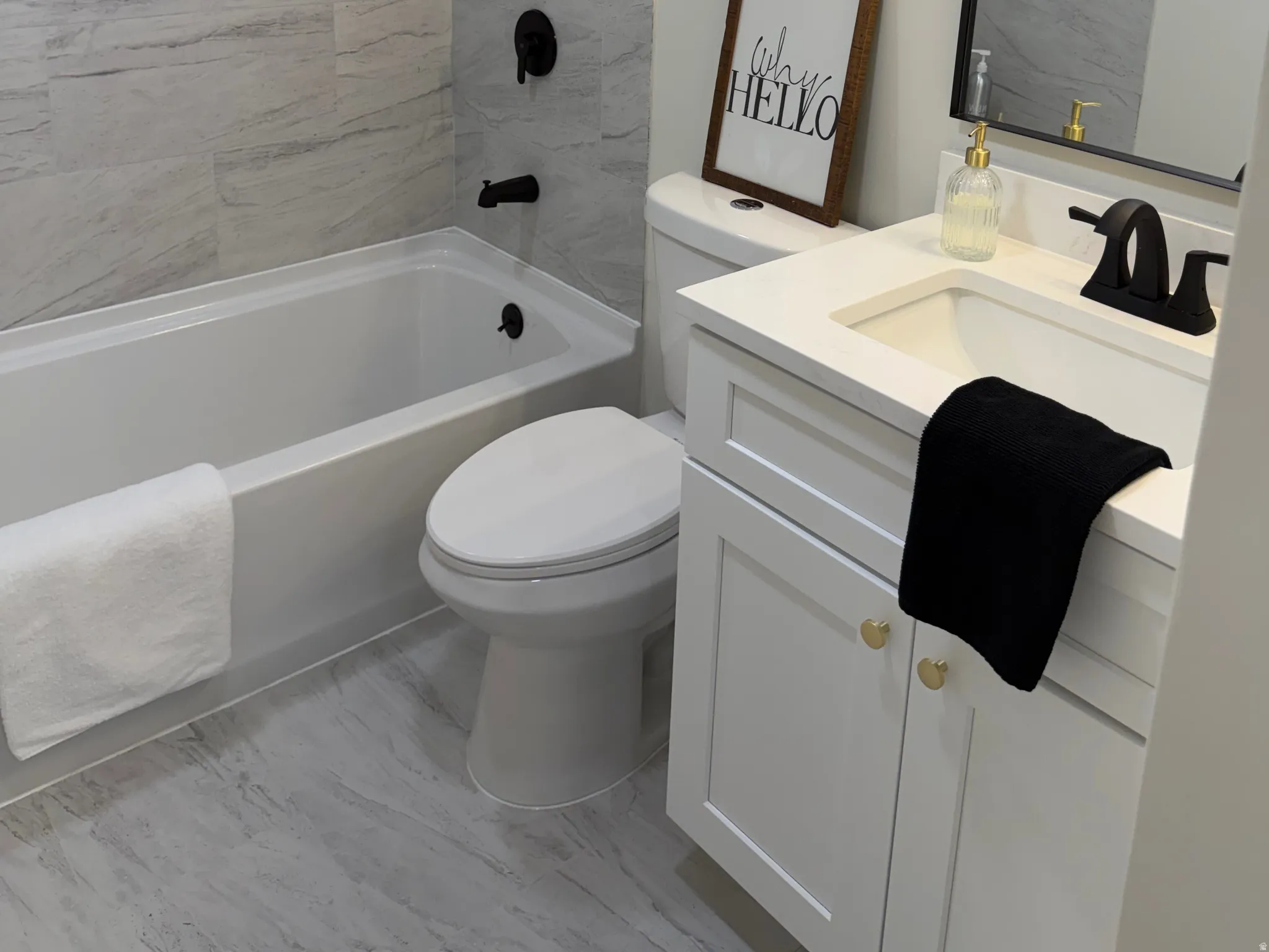 Full bath with vanity, a textured ceiling, and shower / bath combination