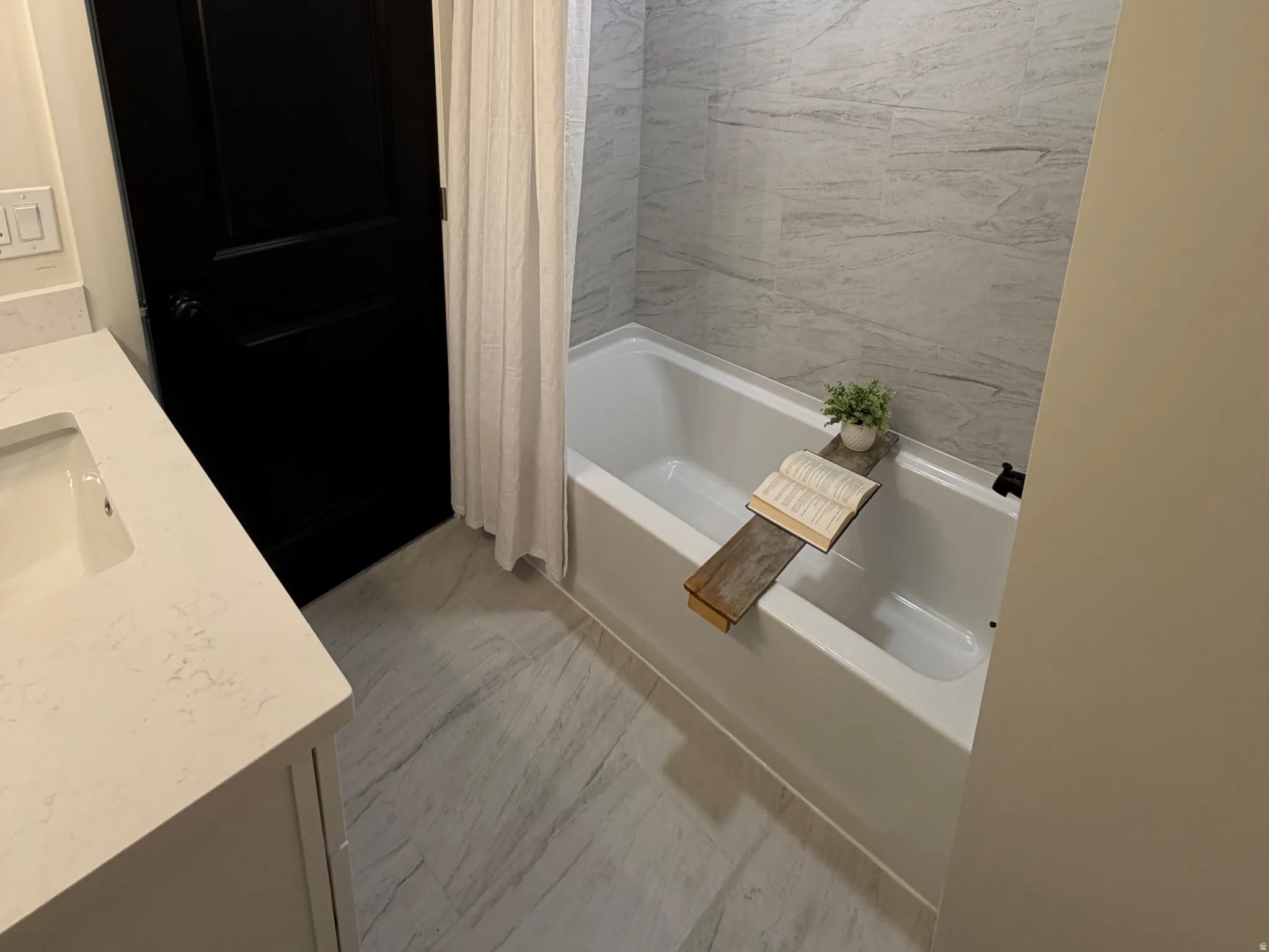 Bathroom featuring vanity, a textured ceiling, shower / tub combo, and recessed lighting