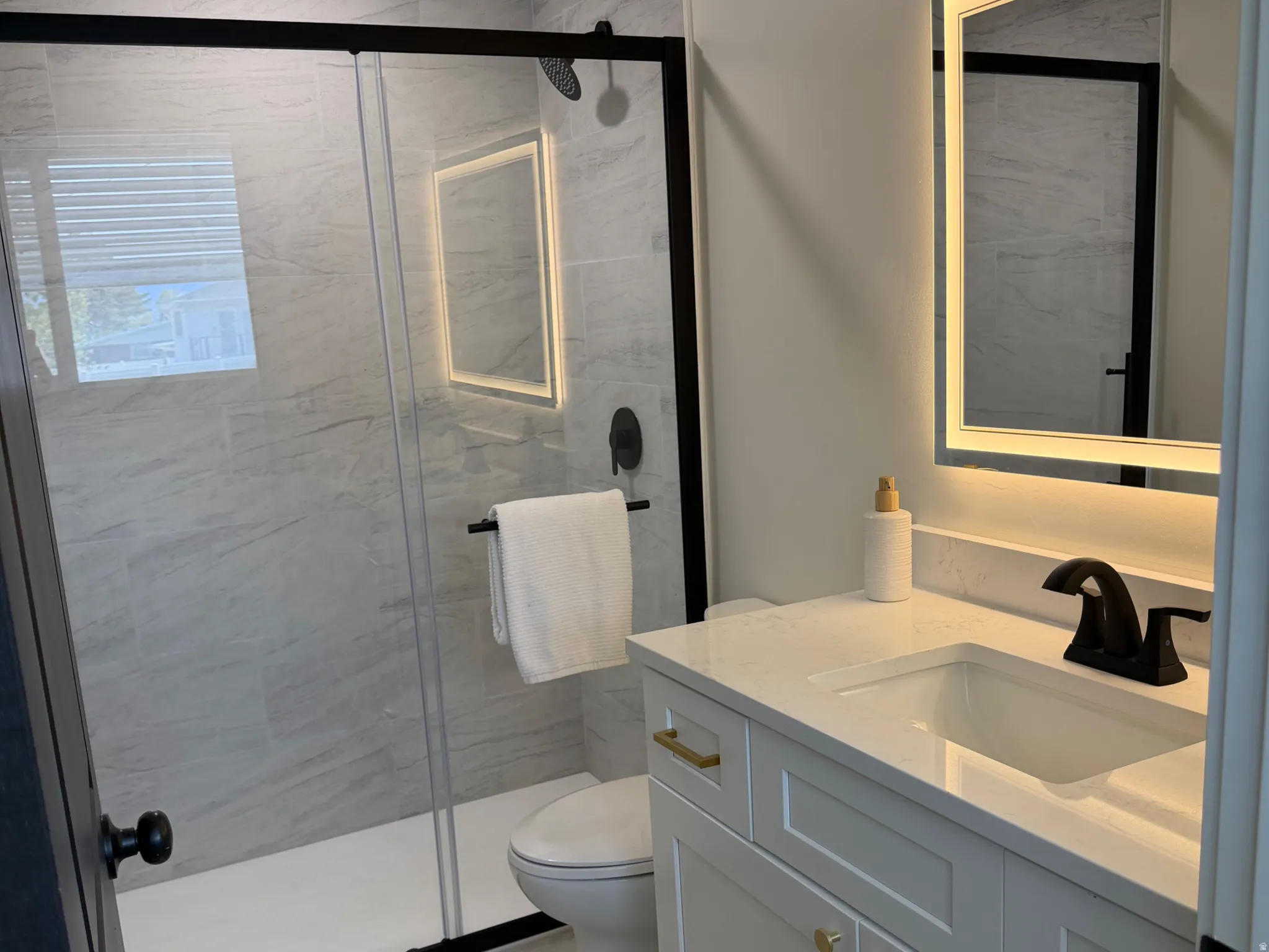 Bathroom featuring vanity and a shower stall